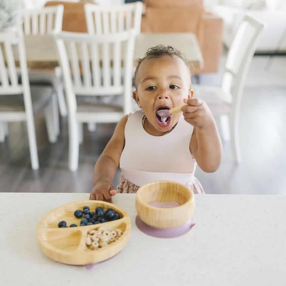 Baby eating from a bamboo bowl